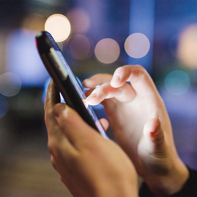 close-up-on-the-hand-of-young-woman-sing-smart-phone-hand-hold-tapping-the-screen